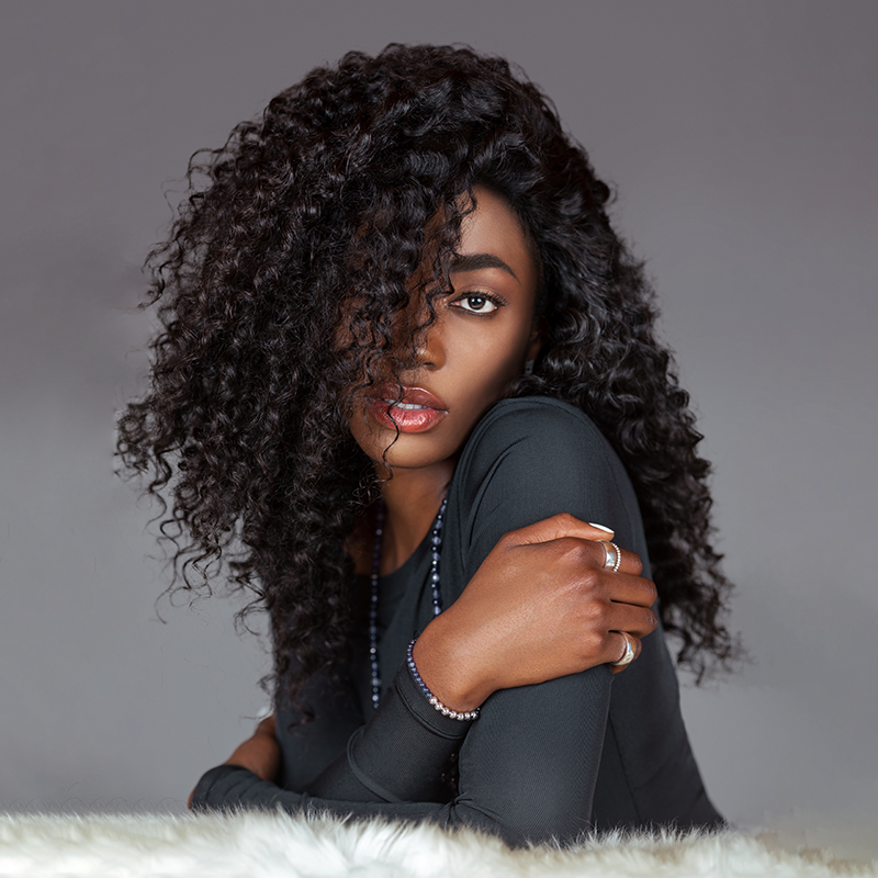 Woman  confidently looking at camera while wearing a Brown Label wig